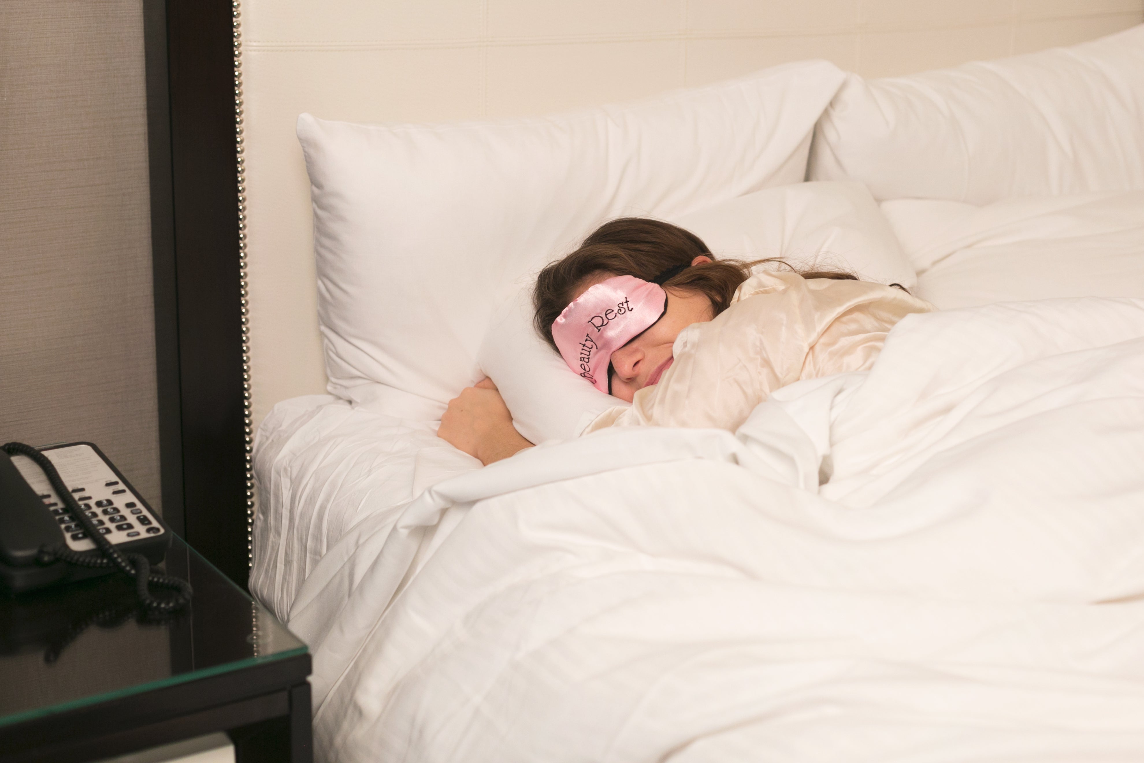 woman resting in bed with eye mask